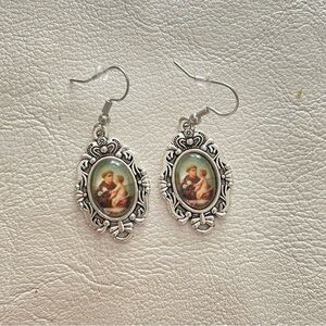Artistic Silver Oval Earrings with Vintage Charm of st. anthony